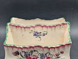 an image of a decorative bowl with flowers painted on it