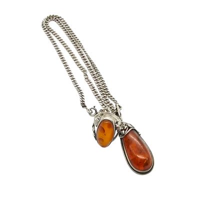 a close up of a necklace on a white background