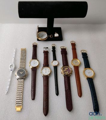 a lot of watches and a watch stand on the table