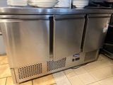 a stainless steel counter with bowls on top of it