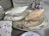 a lot of plates and bowls on the table
