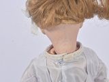 a doll with a red hair and a white dress