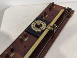 an old fashioned clock is sitting on a white surface