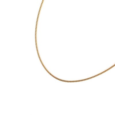 a close up of a gold chain on a white background