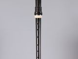 a black and white flute sitting on top of a glass table