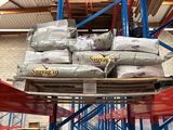 a large stack of bags on a pallet in a warehouse
