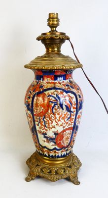 a lamp that is sitting on a stand with a light on it