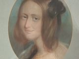 portrait of a young woman with a black flower in her hair