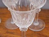 several empty wine glasses sitting on top of a wooden table