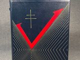 a black and red book with a cross on top of it