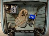an overhead view of an old car with a blue sign in the trunk