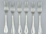 six forks and a knife are arranged in a row