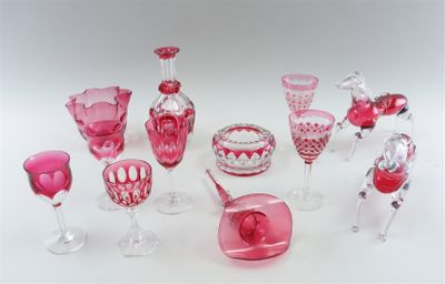 many different pink glass items on a white surface