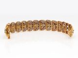 a gold bracelet with a diamond clasp
