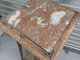 a small table with a marble top in a garage