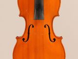 an old violin with a bow hanging from it ' s back