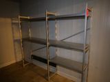 a metal shelf in the corner of a room with a red tag on it