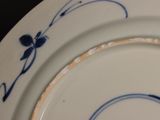 a close up of a plate with a blue and white design on it