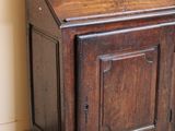 a small wooden cabinet with a door on the top