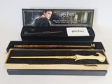 two harry potter wands in a black box with a gold handle