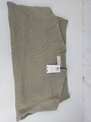 an image of a tan sweater with a tag on it