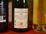 three bottles of wine sitting on a table next to each other