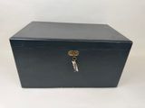 a black metal box with a key on top of it