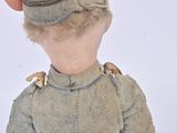 a small doll with a hat on it ' s head