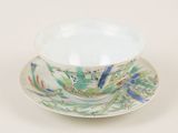 a bowl and saucer on a saucer on a white table