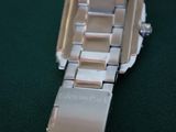 a close up of a watch on a green surface