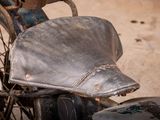 a close up of a motorcycle with a hat on the seat