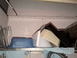 a lot of dishes and pans on a shelf