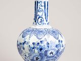a blue and white vase sitting on a table