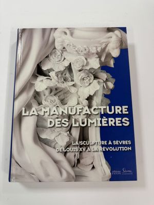the book la manufacture des lumieres is on a table