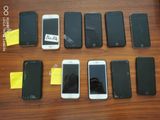several cell phones are lined up in a row on a table