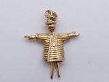 a gold charm that has a little girl on it