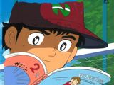image de bande dessinée représentant un garçon en train de lire un livre et portant un bonnet rouge