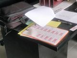 a desk with a laptop and a chair in a room