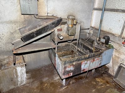 a dirty kitchen with a sink and a stove in it