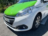 a green and white car parked on the side of the road