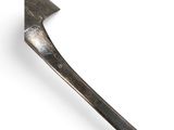 an old axe that is sitting on a white surface