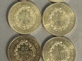 six different british coins sitting on top of each other on a table