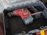a tool box that has a drill and a hammer in it