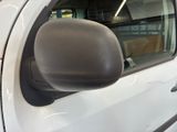 a side view mirror of a white car in a showroom