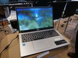 a laptop computer sitting on top of a box on a table