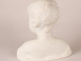 a white statue of a boy with a short hair