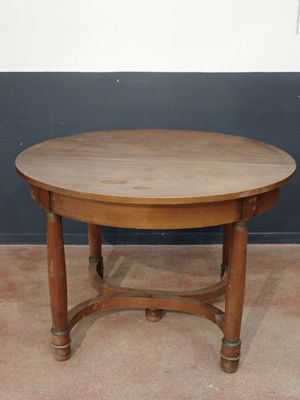 a wooden table with a wooden top on a carpeted floor