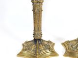 pair of antique brass candlesticks on a white background
