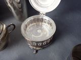 a silver container with a lid sitting on a table
