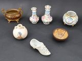 many different types of vases and other items on the table
